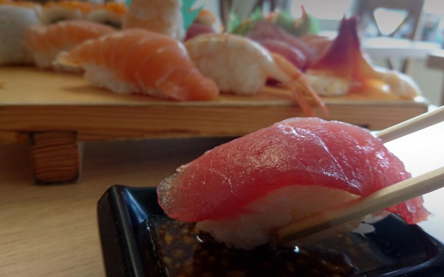 A piece of nigiri sushi dipped into a sludge of soy sauce and wasabi at the Tokyo Oysy Sushi restaurant in the village of Beck Row, England. The restaurant is located only 770 yards from the base and offers delicious eat-in or take-out Asian-inspired dishes.