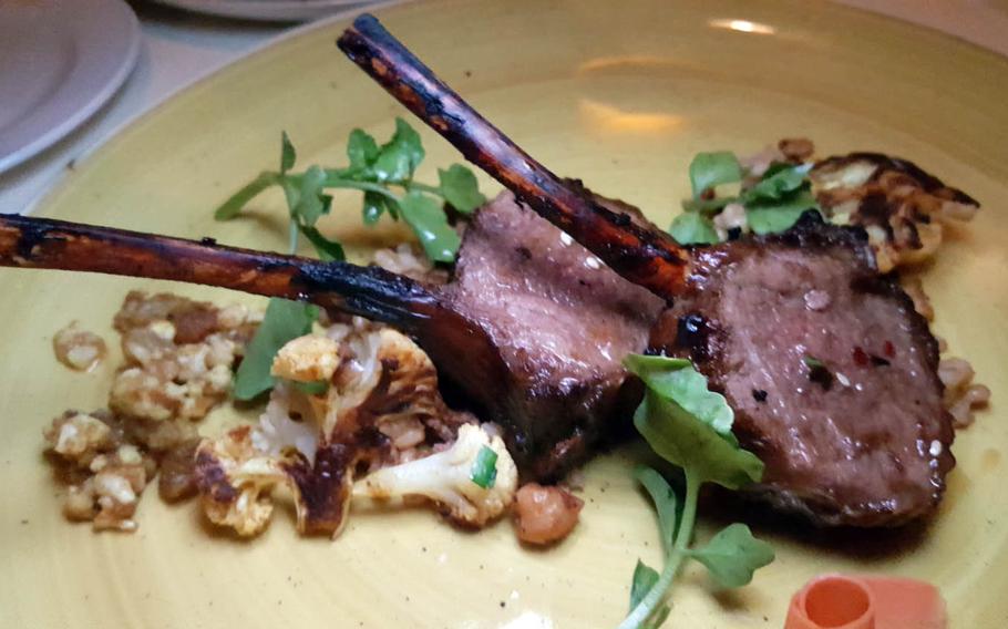 Alan Wong's Colorado lamb chops are glazed in a spicy hoisin sauce and come atop a bed of curried cauliflower.