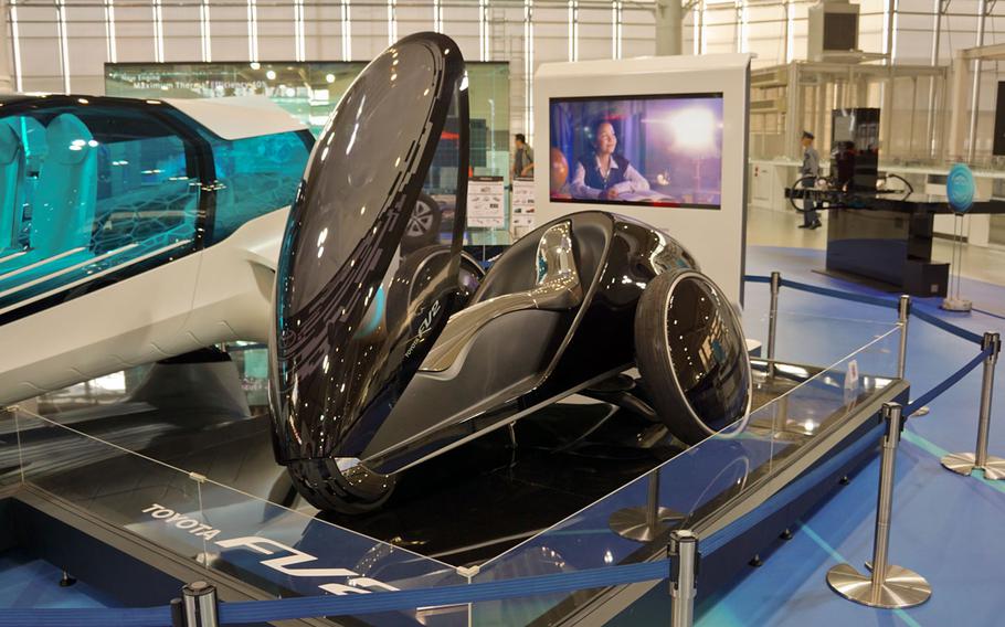 The egg-shaped, three-wheeled Toyota FV2 concept car, which has no steering wheel and is designed to steer by reacting to the driver's movements, is on display at the Toyota City Showcase at Toyota's Mega Web theme park in Tokyo.