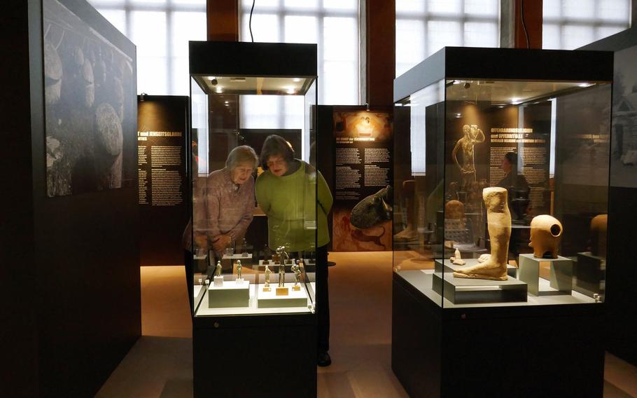 Visitors to the Archaeological Museum in Frankfurt, Germany, look at items on display at the temporary ''Gods of the Etruscans'' exhibit, which runs through February 4, 2018.