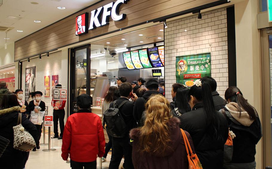 Customers line up to purchase Christmas meals at a KFC near Yokota Air Base, Japan, Monday, Dec. 25, 2017.