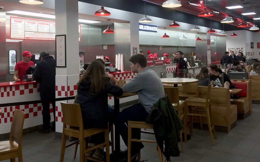 Customers order and eat at Five Guys in Frankfurt, Germany. The chain opened its Frankfurt location - the first in Germany - in December.