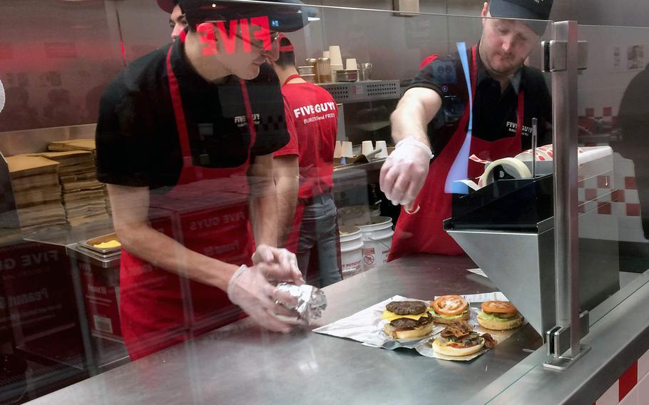Workers prepare burgers at Five Guys in Frankfurt, Germany. The American chain opened its first restaurant in Germany in December.