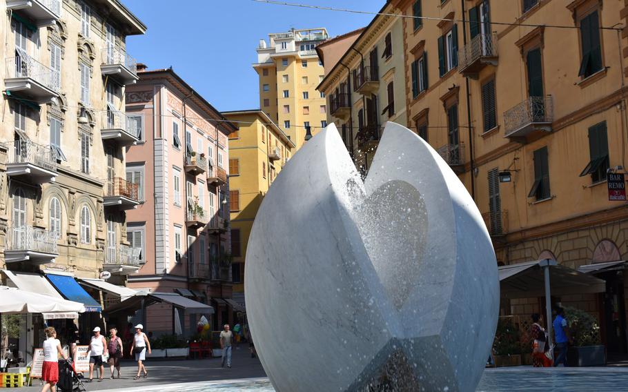 A striking fountain lies in the middle of Piazza Garibaldi in La Spezia, Italy. From some vantage points the fountain's two structures form the shape of a heart.