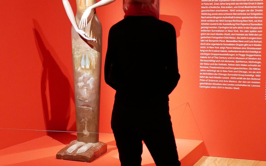 A visitor to the exhibit "Fantastic Women," at the Schirn exhibit hall in Frankfurt, Germany, checks out Leonora Carrington's "Le Grand Dame (Cat Woman)," a piece she did with the sculptor Jose Horna.