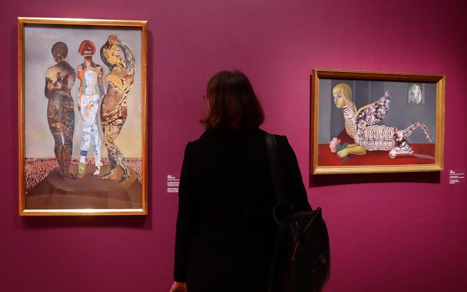 A visitor to the exhibit "Fantastic Women" at the Schirn in Frankfurt, Germany, looks at Jane Graverol's "The Massacre of the Innocents." At right is "The School of Vanity." The exhibit runs through July 5.