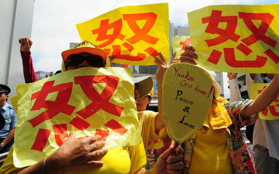 Protesters express anti-base sentiments as Japanese Prime Minister Yukio Hatoyama meets with Okinawa Gov. Hirokazu Nakaima in 2010. 