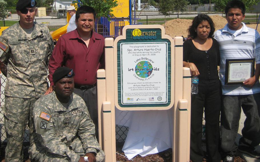 Maj. Andrew Lynch, left, then a captain, attends a playground dedication ceremony with the family of Spc. Arturo Huerta-Cruz, who was killed by the same blast that injured Lynch's right eye. Lynch lost the eye and suffered a tramatic brain injury in the April 2008 attack. He remains on active duty. The playground was dedicated in the name of Huerta-Cruz.