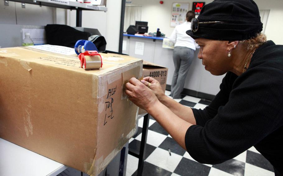 U.S. Army Master Sgt. Eunice Haynes, of the 374th Contracting Squadron, prepares her packages Nov. 1, 2011, at the Yokota Air Base, Japan, post office to send to friends and family in Texas. Haynes said she was hoping to get ahead of the Christmas rush by sending her packages early.