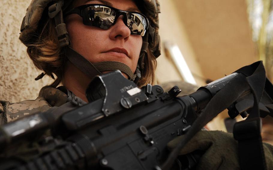 U.S. Army Spc. Rebecca Buck, a medic from Headquarters and Headquarters Company, 1st Battalion, 14th Infantry Regiment, 2nd Stryker Brigade Combat Team, 25th Infantry Division, provides perimeter security outside an Iraqi police station in the Tarmiya Province of Iraq, March 30, 2008. 