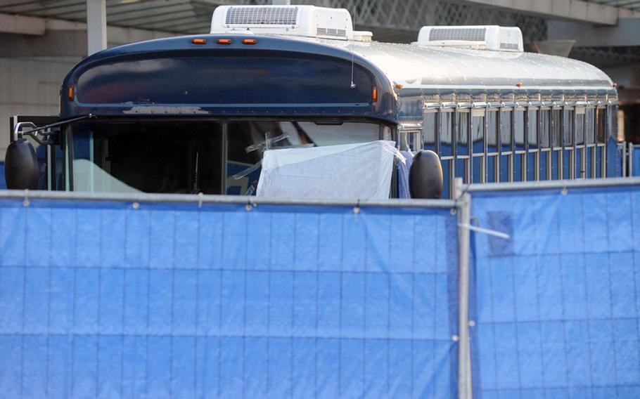 A fence surrounds the military bus where a gunman shot and killed two U.S. airmen and wounded  two others at Frankfurt's international airport in this March photo. 
