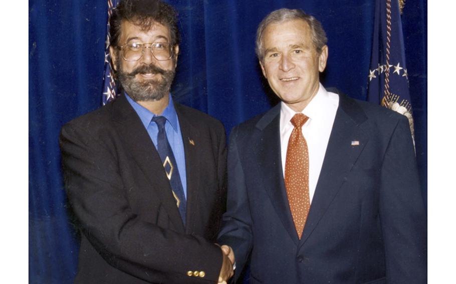This undated photo shows the man known as Bobby Charles Thompson with then-President George W. Bush.