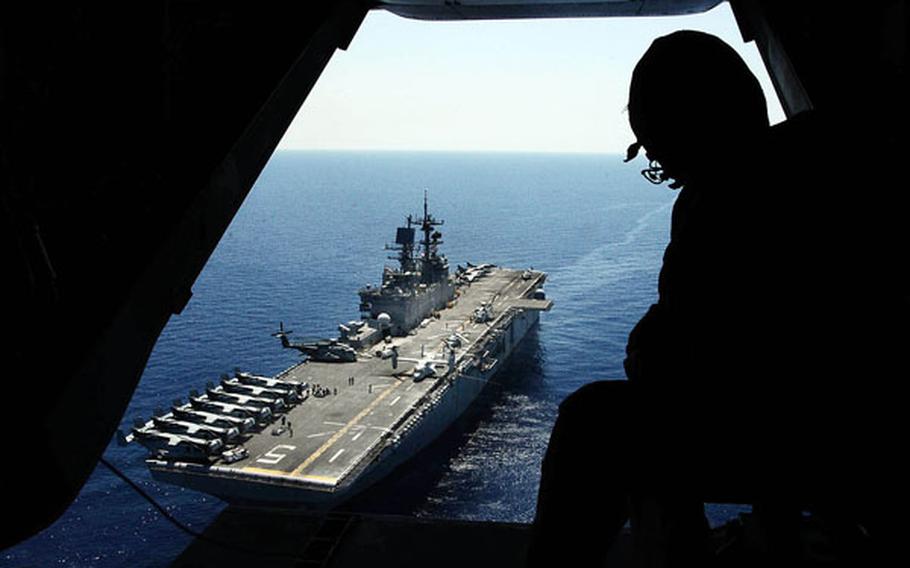 A Marine observes flight operations on the USS Bataan on May 16, 2011, during the ship's deployment in the Mediterranean region. Due to the effects of sequestration, the Navy said in 2013 that it is planning to cancel some training for the amphibious strike group.