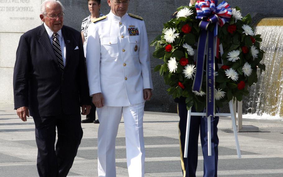 World War II veteran and former Congressman Bob Michel, left, and Joint Chiefs of Staff Chairman Adm. Mike Mullen place a wreath at the National World War II Memorial in Washington as part of Monday's Memorial Day ceremony.