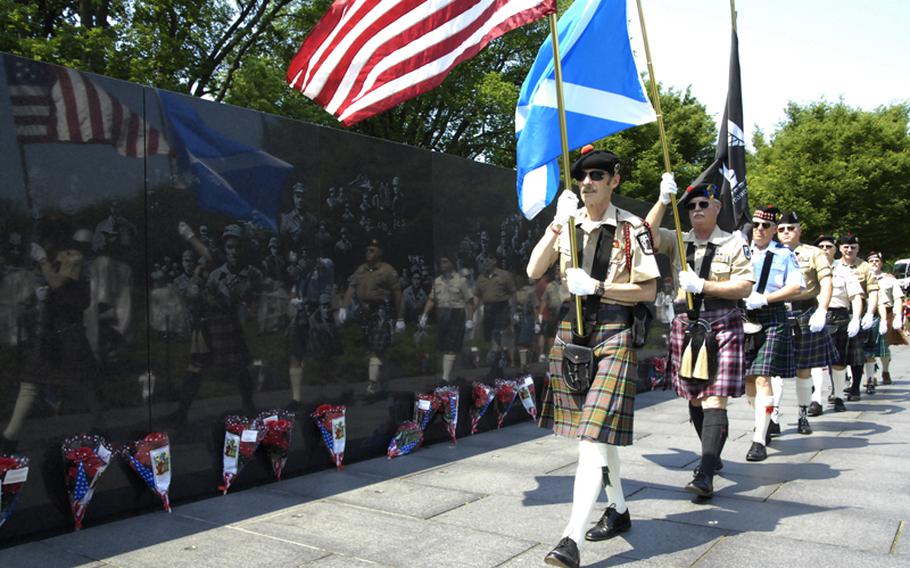 A delegation from the Scottish American Military Society arrives at the Korean War Memorial for a wreath-laying ceremony Monday morning.