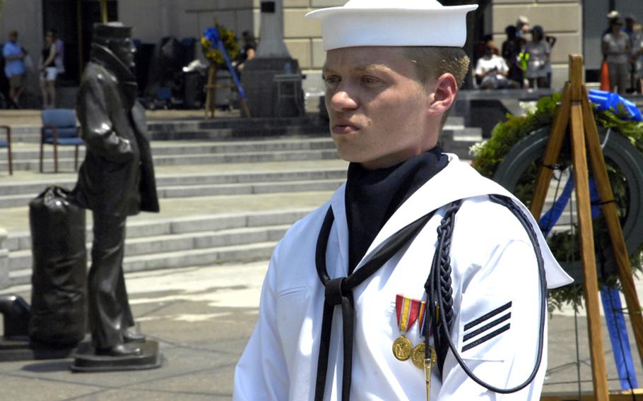 A sailor awaits the start of a wreath-laying ceremony at the Navy Memorial.