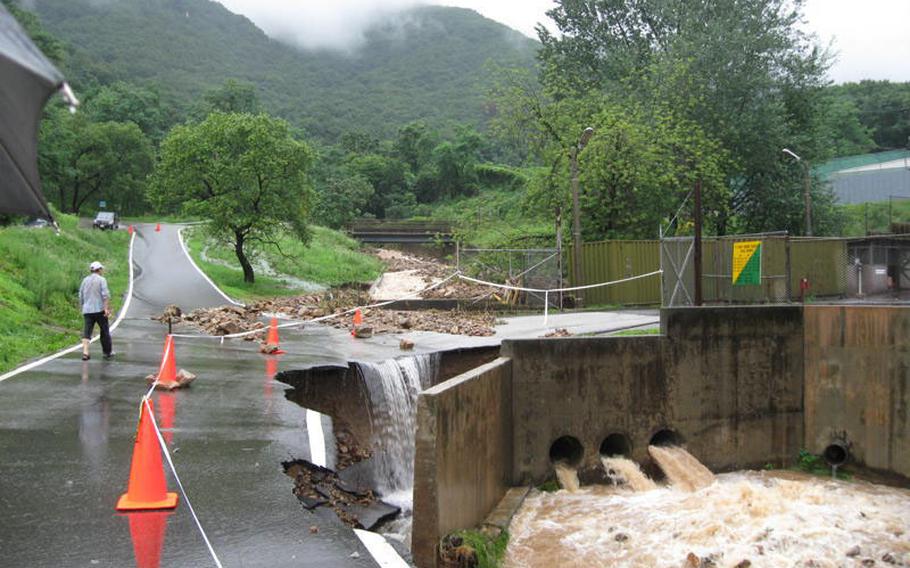 Heavy rains in South Korea washed out part of a roadway July 28, 2011, at Camp Casey in Dongducheon, where four landslides essentially shut down the base.
