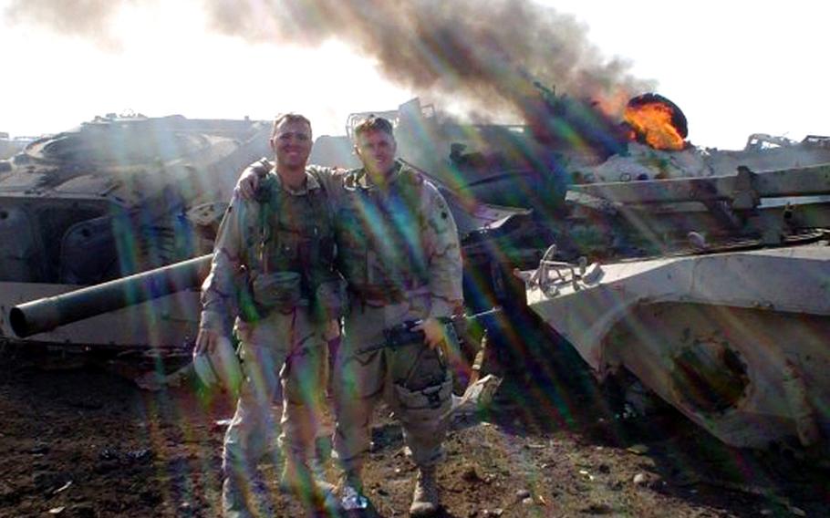 During the Iraq invasion, Stephen Kraft, right, and his Army buddy Clint Auschwitz pose in front of an inoperable tank in an Iraqi junkyard that their unit had just destroyed to keep enemy fighters from using the tank rounds as improvised explosive devices.
