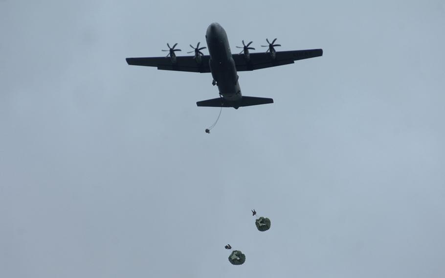 A C-130 releases paratroops during a morning jump at the Hohenfels training area on Wednesday, part of a month-long exercise. Twenty-five soldiers were transported to the hospital with injuries following the jump. 