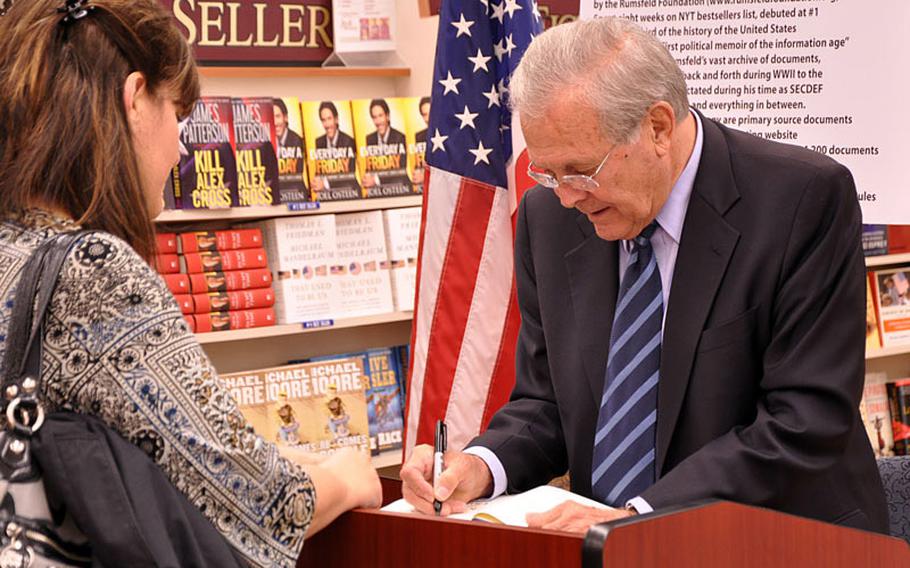 Donald Rumsfeld signs copies of his book, "Known and Unknown: A Memoir," at Yokosuka Naval Exchange on Saturday.