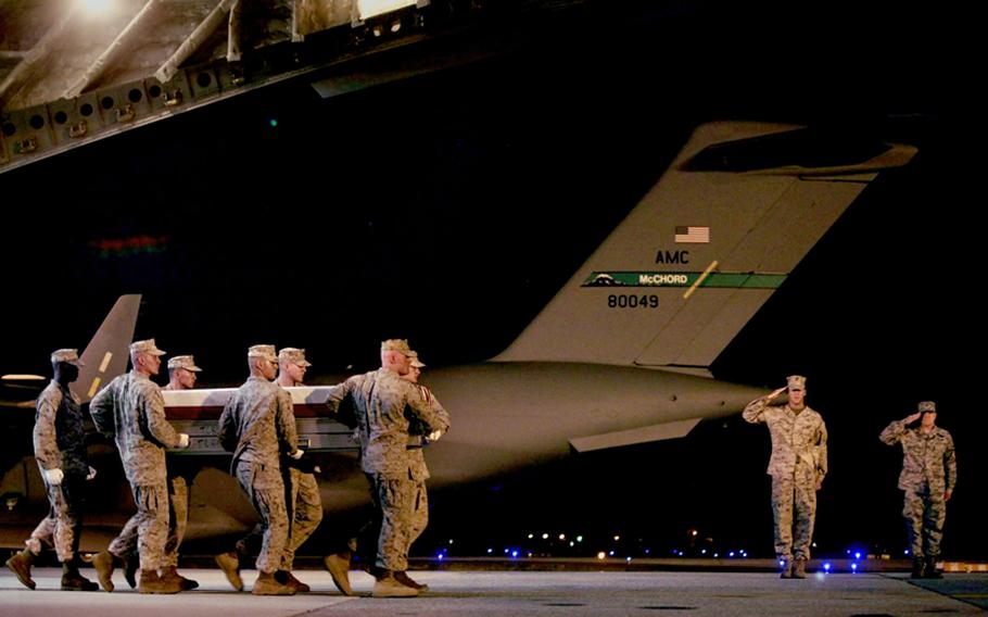 Marines carry the remains of a fallen comrade from an aircraft at Dover Air Force Base on June 23, 2011.