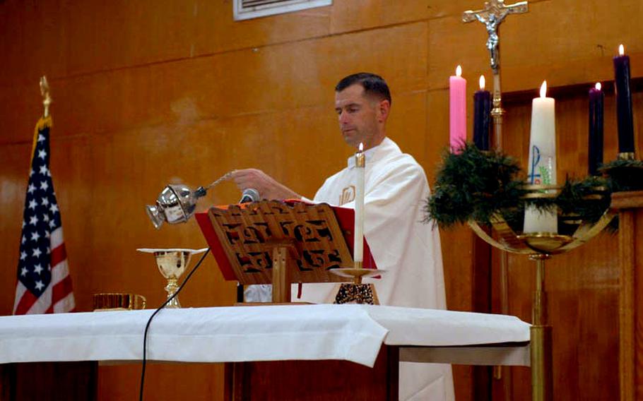 Capt. Joel Panzer fills the chapel at Iraq's Camp Liberty with the smell of incense during a Christmas Mass in December 2010.