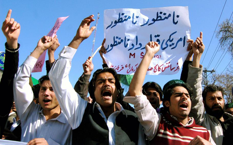 Pakistani students shout slogans during a protest rally against Quran burning in northwest Pakistan's Peshawar area on February 22, 2012.