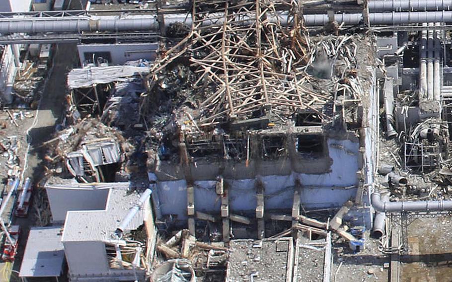 This handout aerial photo dated March 20, 2011, taken by small unmanned drone shows damaged Unit 4, left, and Unit 3 of the crippled Fukushima Daiichi nuclear power plant in Okumamachi, Fukushima prefecture, northern Japan. 
