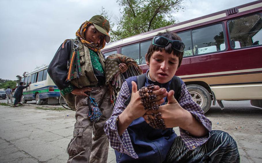 Samir, 10, and Wais, 12, are newcomers to street sales. Both began in the last few months, selling bracelets and other inexpensive items to American and coalition troops walking between bases in a secure area of Kabul.
