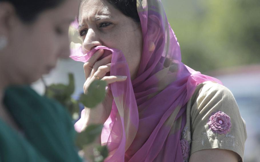 
A woman looks on near the scene of a shooting at the Sikh Temple in Oak Creek, Wisconsin on Aug. 5, 2012. 

