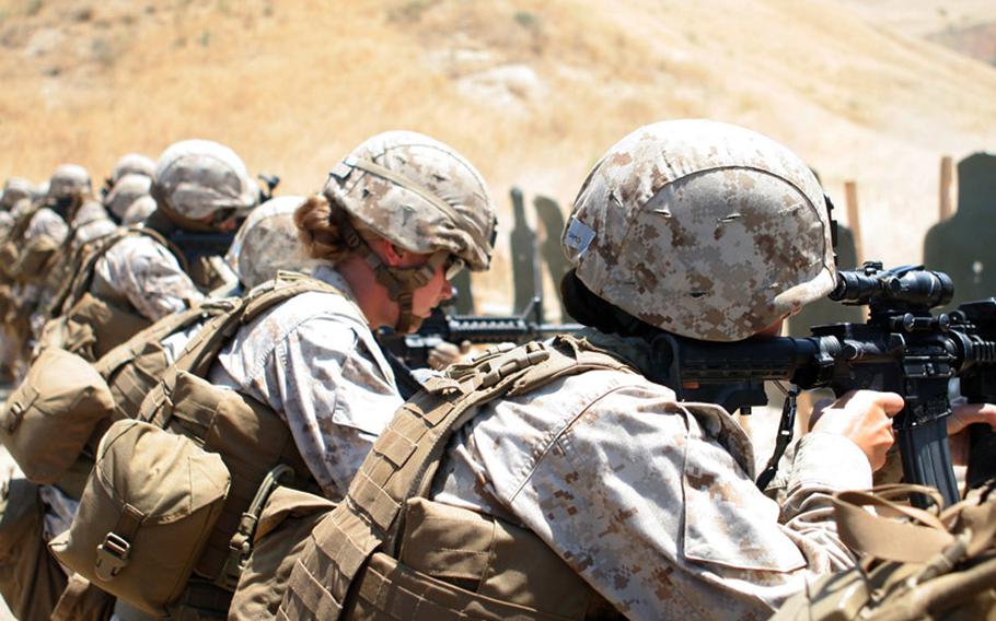 Marines with a Female Engagement Team fire at paper targets during a combat marksmanship training exercise at Camp Pendleton.