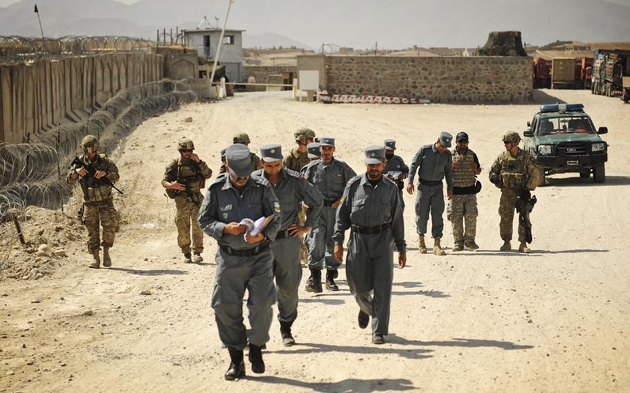 Afghan Uniformed Police lead the way on a joint patrol with coalition troops in Afghanistan's Laghman province, in September 2011.
