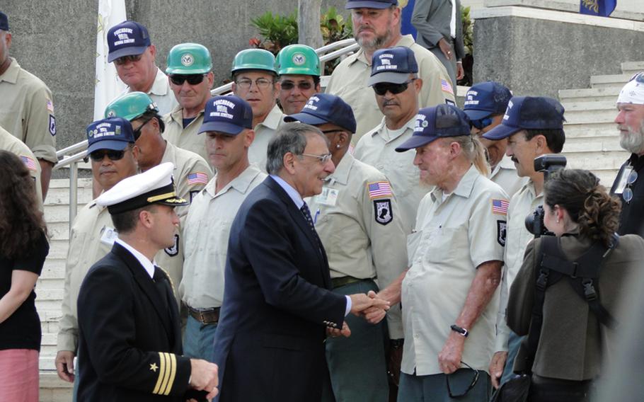 Defense Secretary Leon Panetta shakes hands with the men who work at the National Memorial Cemetery of the Pacific in Hawaii. Panetta paid tribute to the nation's veterans during a Veterans Day observance before embarking on a trip to several nations in the Pacific.
