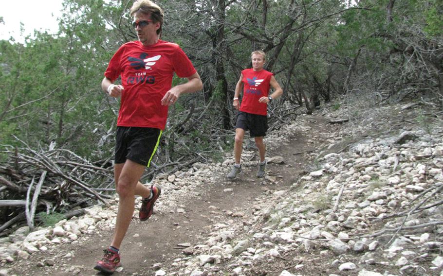 Doug Ratliff (left) and Army Master Sgt. Mike Morton speed down a hillside during Team Red, White & Blue's November running camp in west Texas.
