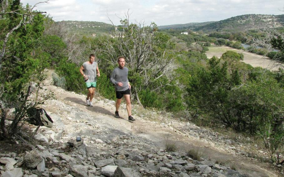 Army veterans Jim Buzzell (right) and Dustin Levijoki speed up a mountainside during Team Red, White & Blue's November running camp in west Texas.
