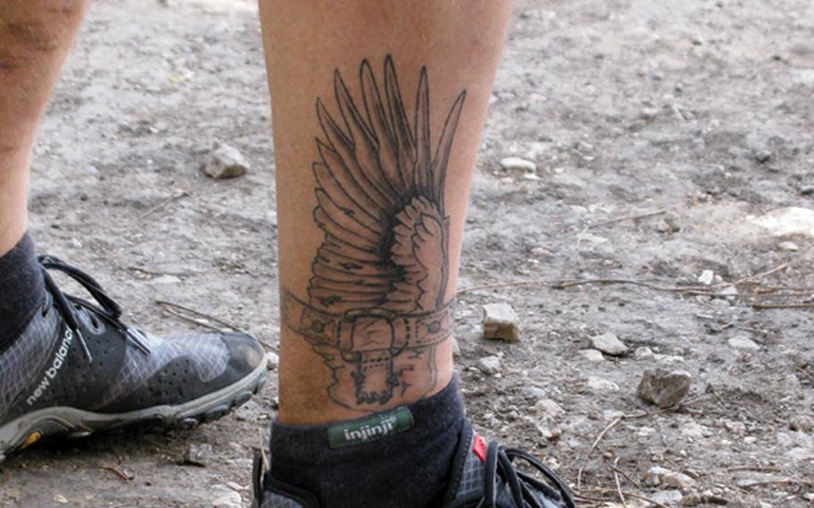 Matching tattoos on Army veteran Jim Buzzell's legs reflect his love of running.