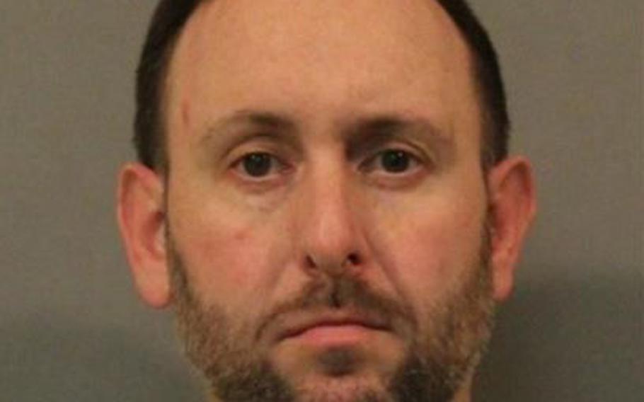 Timothy R. Thomas, a police officer with the Department of Veterans affairs, is charged with murdering Navy veteran Nicholas Lile, 42, on Jan. 3 while drinking with their spouses and friends in the basement of Liles’ Lowell, Ind. home.