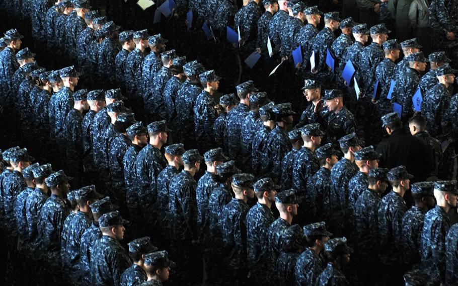 Newly promoted petty officers stand in formation in thier NYCO uniforms aboard the USS George Washington during a frocking ceremony Dec. 7, 2012. The nylon-and-cotton uniforms worn by sailors on ships and at bases “will burn robustly,” and turn into a “sticky molten material,” according to a test conducted by the Navy Clothing and Textile Research Facility.