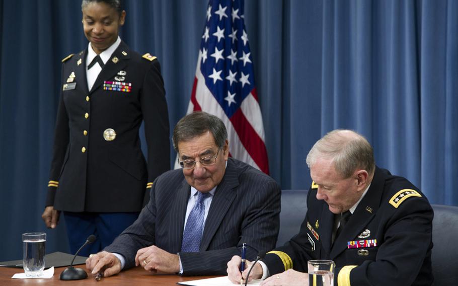 Secretary of Defense Leon Panetta and Chairman of the Joint Chiefs of Staff Gen. Martin Dempsey sign a memorandum for a women in service review during a press conference with media at the Pentagon in Washington, D.C., on Jan. 24, 2013. The memorandum rescinds the 1994 Direct Ground Combat Definition and Assignment Rule excluding women from assignment to units and positions whose primary mission is to engage in direct combat on the ground.