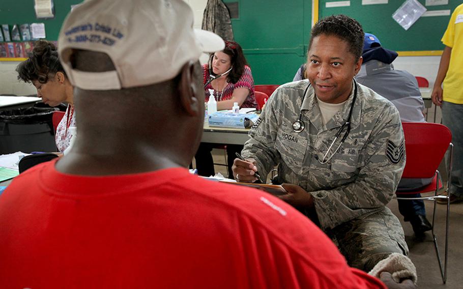 Tech. Sgt. Jamal J. Hogan, right, with the New Jersey Air National Guard, takes down medical information of a homeless veteran at the National Guard Armory in Cherry Hill, N.J., on Sept. 28, 2012.