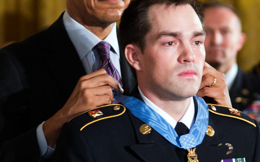 President Barack Obama presents the Medal of Honor to former Army Staff Sgt. Clinton Romesha on Feb. 11, 2013, at the White House.