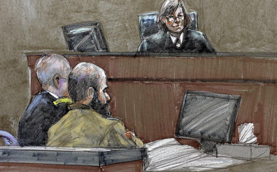 In this August, 2013 courtroom sketch, Maj. Nidal Hasan, center, sits before the judge, U.S. Army Col. Tara Osborn, at the Lawrence William Judicial Center during the sentencing phase of his trial in Fort Hood, Texas.