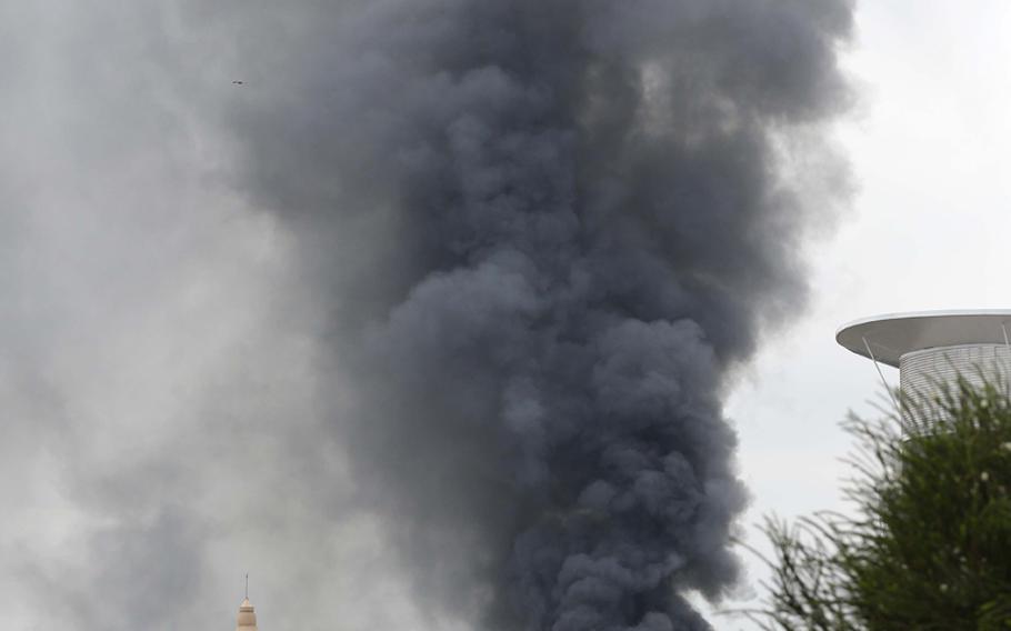 Thick smoke rises from the Westgate Shopping Centre in Nairobi after a string of explosions during the 3rd day of a standoff between Kenyan security forces and al-Qaida-allied Al-Shabab gunmen inside the building in Nairobi, Kenya, on Sept. 23, 2013.