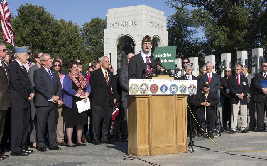 Ray Kelley, VFW's national legislative director, is joined by representatives of several veterans groups as he speaks at a press conference at the National World War II Memorial in Washington on Oct. 15, 2013.