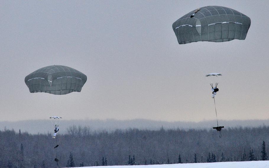 Paratroopers with the 1st Squadron (Airborne), 40th Cavalry Regiment prepare for their parachute landing fall during an Arctic airborne operation in the over-white uniform on Malemute Drop Zone at Joint Base Elmendorf-Richardson, Alaska, Dec. 12, 2013. 