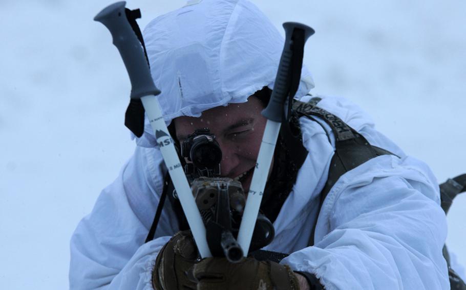 Staff Sgt. Bruce Henderson, an infantryman with 4th Infantry Brigade Combat Team (Airborne), 25th Infantry Division, uses crossed ski poles to steady his aim Dec. 12, 2013 at the Malemute Drop Zone at Joint Base Elmendorf-Richardson, Alaska.