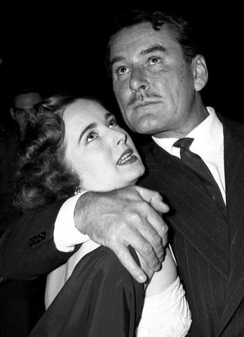 A lucky fan meets Errol Flynn at a March of Dimes benefit in Frankfurt in February, 1954.