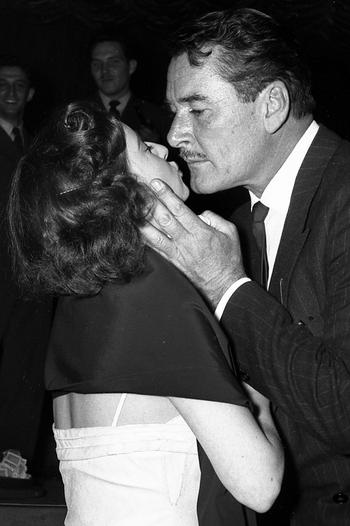 A fan gets a kiss from Errol Flynn at a March of Dimes benefit in Frankfurt in February, 1954.
