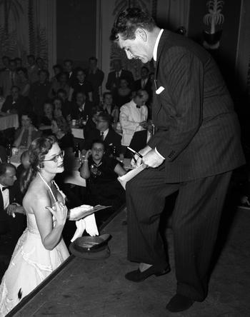 Errol Flynn signs an autograph at a March of Dimes benefit in Frankfurt in February, 1954.
