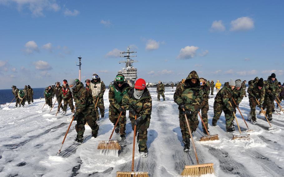 Sailors on the USS Ronald Reagan scrub the aircraft carrier’s deck to remove potential radiation contamination during Operation Tomodachi, the humanitarian response to the earthquake and tsunami that ravaged northeast Japan and caused a nuclear meltdown at Fukushima in March 2011.